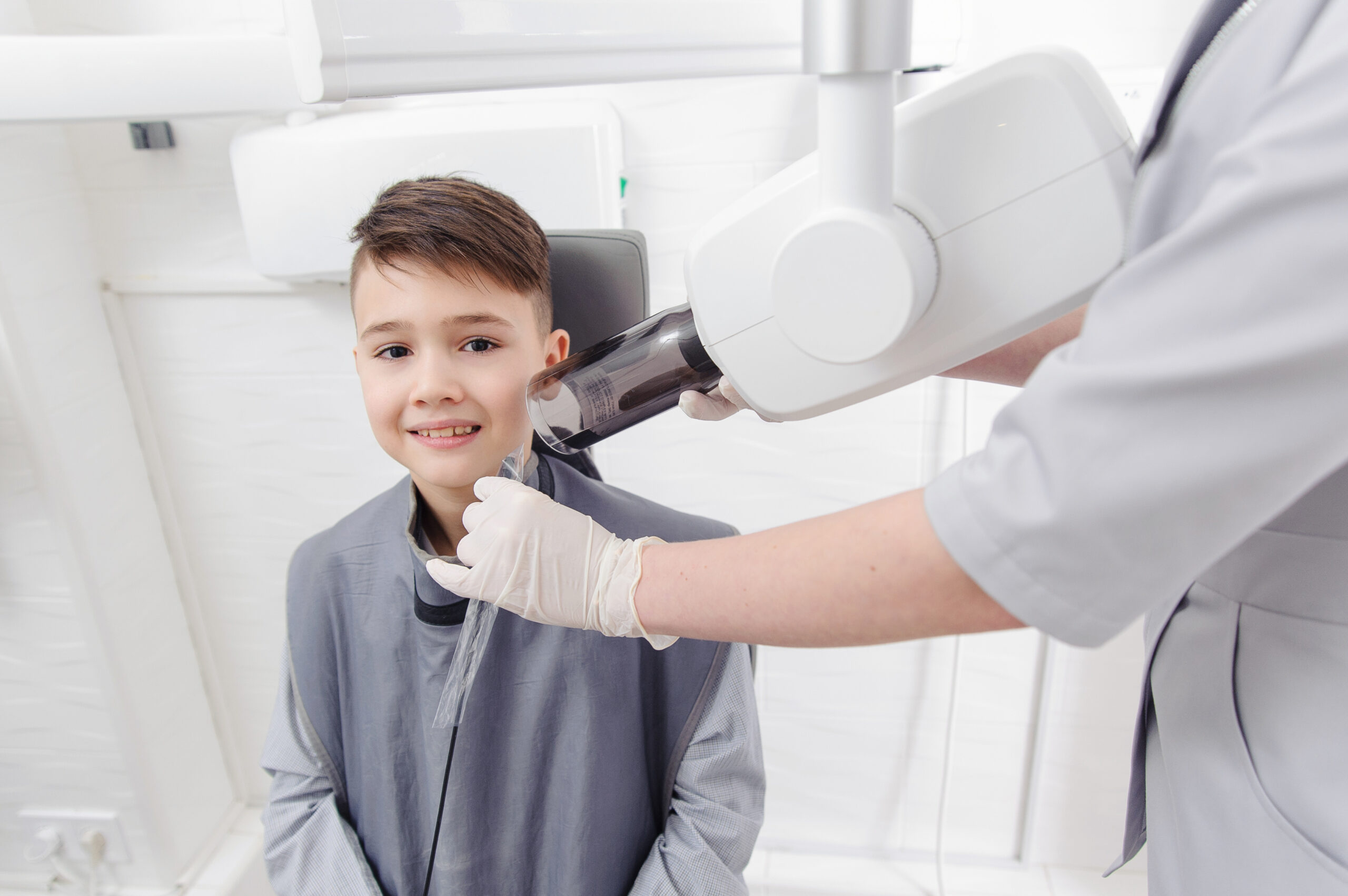 Family smiling together during a back-to-school dental visit